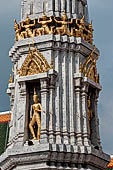 Bangkok Wat Pho, phra prang tower at the corner of the courtyard around the bot. Khmer-style statues guardian of the cardinal points. 